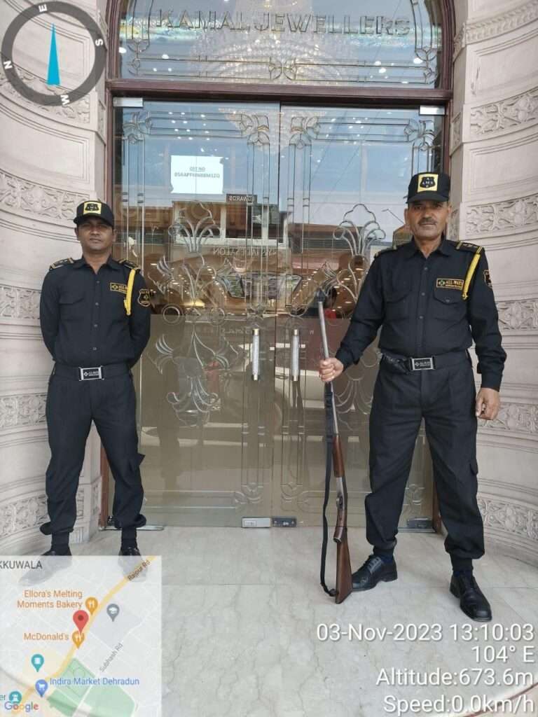 One gunman and one security guard standing in front of a jewellery shop entrance